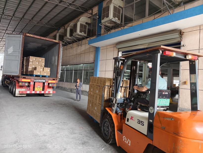 Forklift loading paper product cartons onto container — Kosda Ningbo facility
